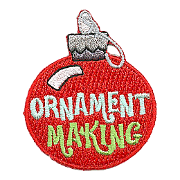 A red glass ornament with the words Ornament Making across it. 