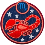 This circular crest displays a red scorpion surrounded by stars. The sign of Scorpio sits above it.