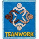 Four people with different skin tones link arms. The word Teamwork is below them.