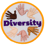 This circular crest displays hands of different skin colour to represent diversity.