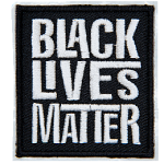 A black rectangle has the words Black Lives Matter embroidered in grey thread. Each word is stacked on top of the next.