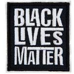 A black rectangle has the words Black Lives Matter embroidered in grey thread. Each word is stacked on top of the next.