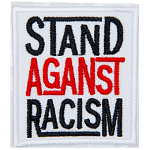 A white rectangle has the words Stand Against Racism embroidered in black, red, and black thread, respectively. Each word is stacked on top of the next.