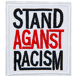 A white rectangle has the words Stand Against Racism embroidered in black, red, and black thread, respectively. Each word is stacked on top of the next.