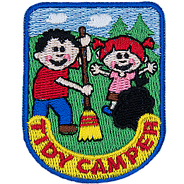 A boy and a girl work together to clean up their campsite and show that they are tidy campers.