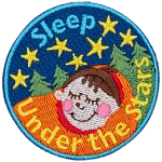 A child is tucked tight in a sleeping bag as they nap under a starry sky.