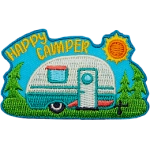 The words Happy Camper are in the sky above a camper on a sunny day.