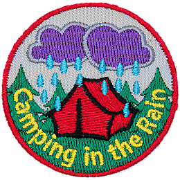 Dark clouds pour rain down on a tent in the woods during a night of camping in the rain.