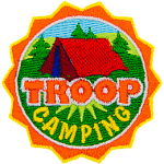 This round crest displays the text Troop Camping with a tent set up in a grassy field.