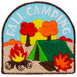 Autumn leaves fall on a tent and campfire, symbolizing fall camping.