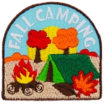 Autumn leaves fall on a tent and campfire, symbolizing fall camping.