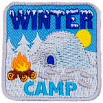 An igloo sits next to a campfire in a field of snow, symbolizing a winter camp.