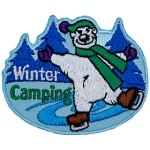 A polar bear skates on a tree-lined pond next to the text Winter Camping.
