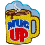 A mug is filled with steaming hot liquid.