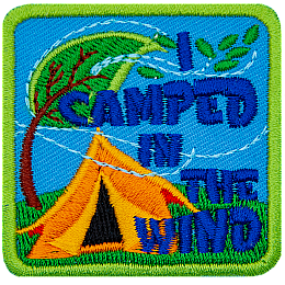 The words I Camped In The Wind are next to a yellow tent and a tree blown by the wind.