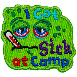 A green patch with a sad face. The words I Got Sick At Camp are on it.