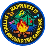 The words Happiness Is Sitting Around The Campfire in a circle around a camping tent and campfire.