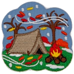A single tent sitting next to a campfire is framed by two bare trees. Snow and leaves are blown across the patch.
