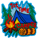 The words 1st Time Camper are around a blue tent and campfire.