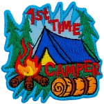 The words 1st Time Camper are around a blue tent and campfire.