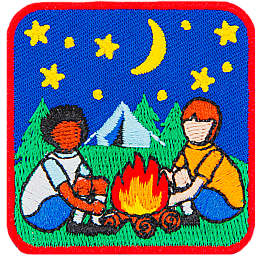 Two kids sit around a campfire with the night sky and a tent behind them.