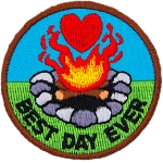 A campfire with a heart above it. The words Best Day Ever are in an arc across the bottom.