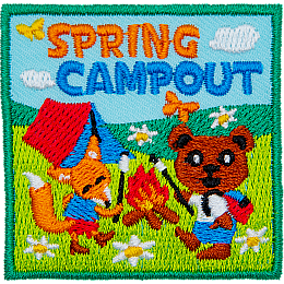 An anthropomorphic bear and a fox roast marshmallows over a campfire. A tent is behind them in an open meadow. Spring Campout is stitched above.