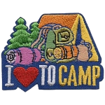 A tent, sleeping bag and backpack sit on top of the words I Love To Camp.