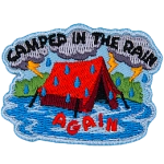 A red tent is caught in the rain. The words Camped In The Rain surround it.