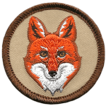 A forward-facing red fox head on a brown background.