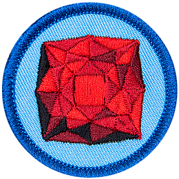 A red garnet is in the centre of a circular blue badge.