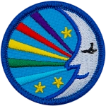 A sleeping moon with five rainbow strands coming out of it.
