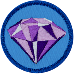 A sparkling purple amethyst on a blue background.