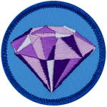 A sparkling purple amethyst on a blue background.