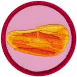 An amber gemstone on a pink background.