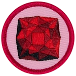 A red garnet is in the centre of a circular pink badge.