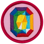 A rainbow gemstone on a pink background.