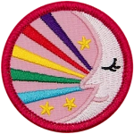 A sleeping moon with five rainbow strands coming out of it.