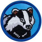 A badger face on a blue background.