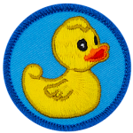 A yellow rubber duck stares vacantly off to the right of this round, merrow border patch.