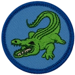 A green alligator with its tooth-filled mouth open facing left on a blue background.