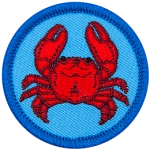 A crab is viewed from the top down on this circular crest.
