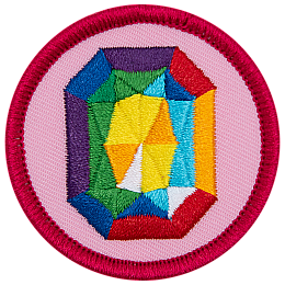 A rainbow gemstone on a pink background.