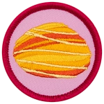 A fire opal is in the centre of a circular pink badge.