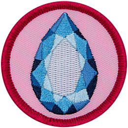 A sapphire surrounded by a ring of yellow on a pink background.