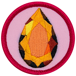 A sparkling topaz gemstone is in a teardrop shape on a circular background.