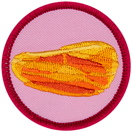 An amber gemstone on a pink background.