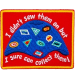 A camp blanket covered in patches, crests, and badges. The text reads, I didn't sew them on, but I sure can collect them!