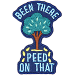 A tree sits between the words Been There Peed On That with little yellow droplets coming out of it.