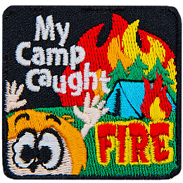 A burning tent is in the background, with a panicked child in the foreground. The text reads My Camp Caught Fire.